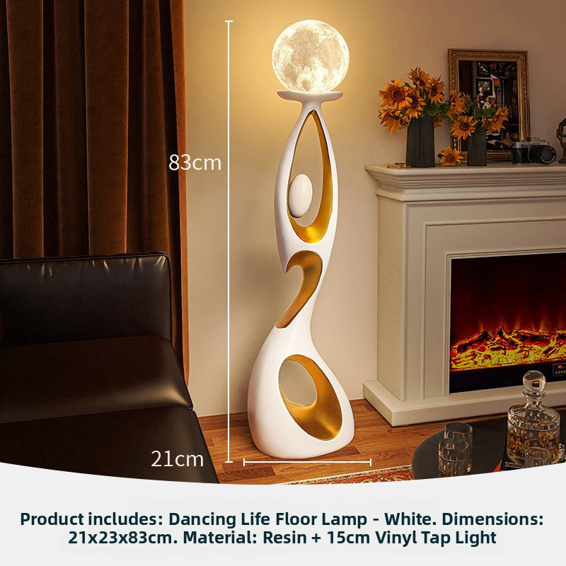 White Dancing Life floor lamp with glowing globe beside a fireplace