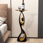 Black Dancing Life floor ornament holding a wine bottle on its tray beside a bed