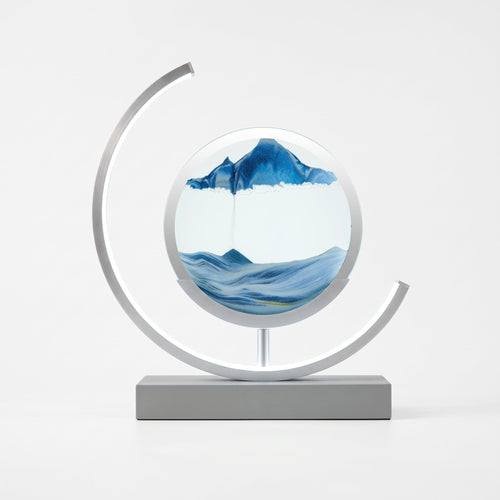DRAPMODE glass quicksand table lamp with blue flowing sand in a circular frame, featuring touch dimming LED light.