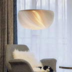 Nordic parchment pendant light with warm glow in a minimalist interior