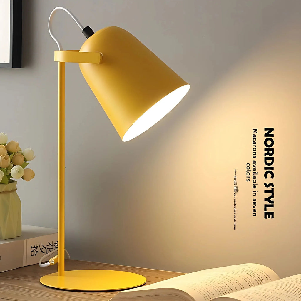 Yellow table lamp on a wooden surface with a blurred background