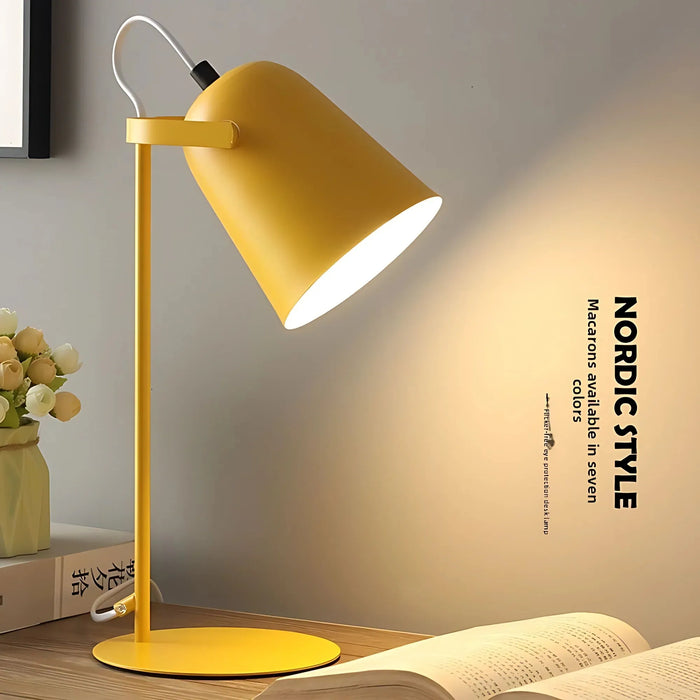 Yellow table lamp on a wooden surface with a blurred background