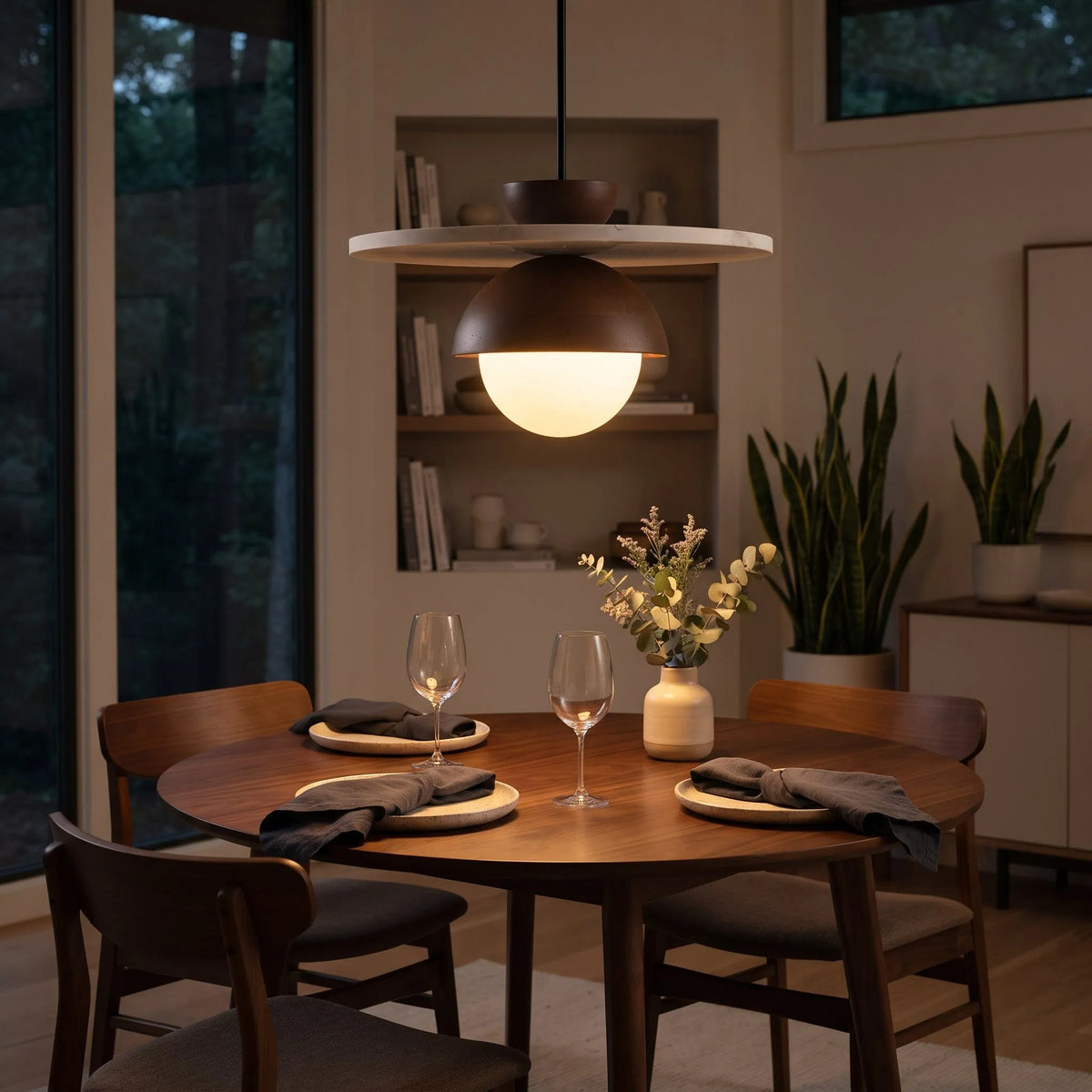 Walnut pendant light hanging over a dining table