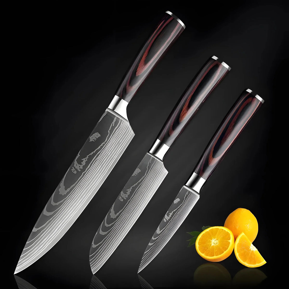 Three Damascus pattern knives with wood handles beside fresh oranges on a black background