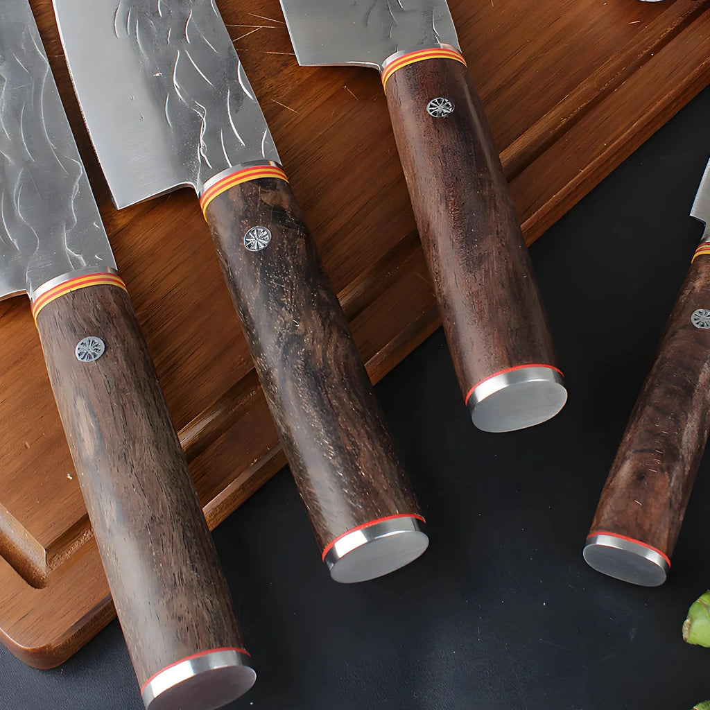 Close-up of forged knife wooden handles with metal end caps on a wooden board