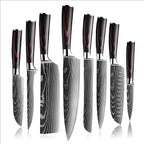 Eight kitchen knives with Damascus pattern blades and wood handles standing in a row
